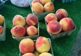 Fresh peaches for sale at a market.