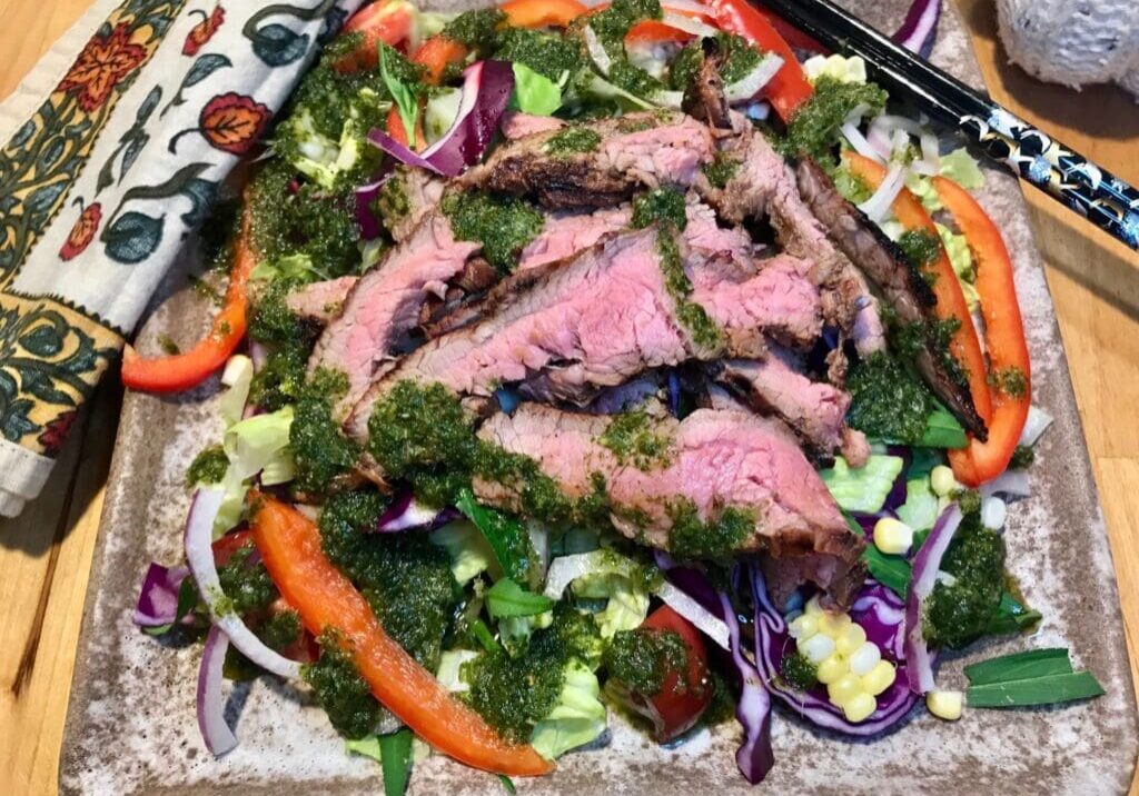 Steak salad with red peppers and herbs.