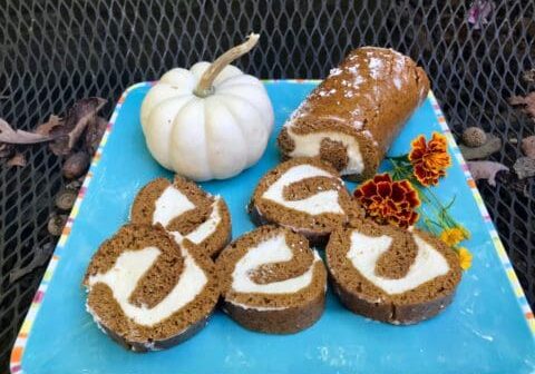 Pumpkin spice roll slices on a blue plate.