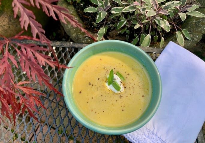 A bowl of soup on the ground outside