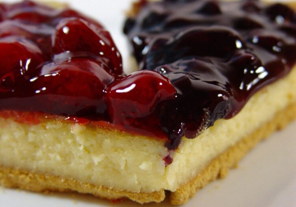 A piece of cheesecake with berry topping on top.