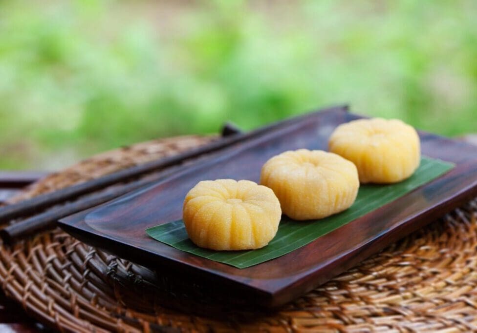 Three small pastries on a wooden tray