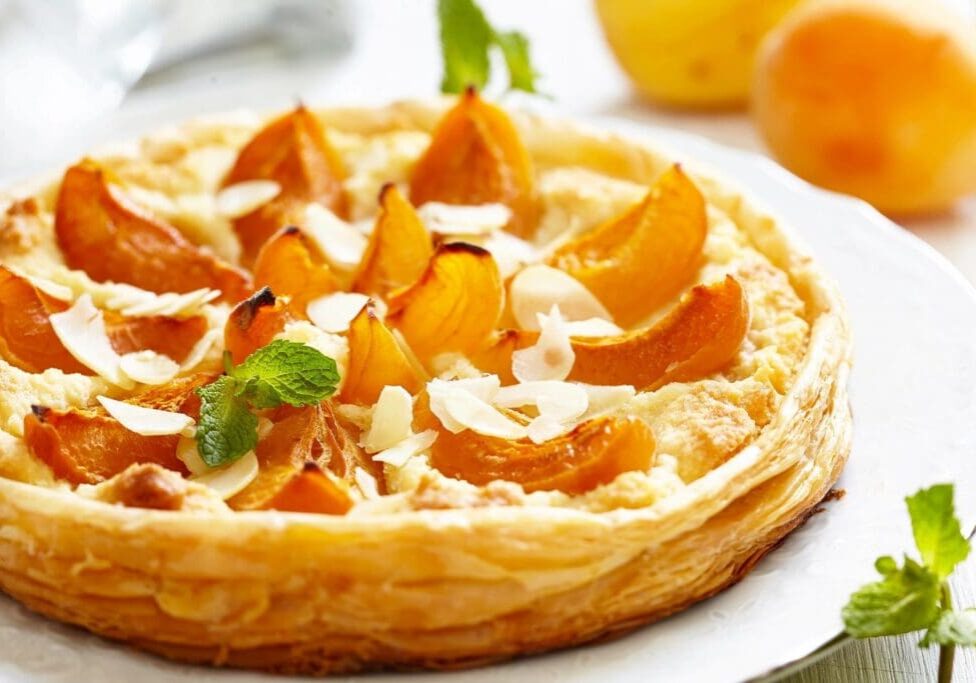 A close up of an orange and almond pastry