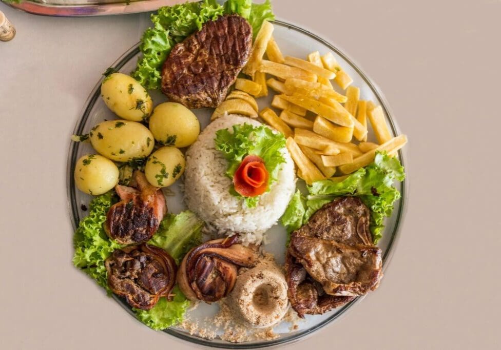 A plate of food with meat, potatoes and vegetables.