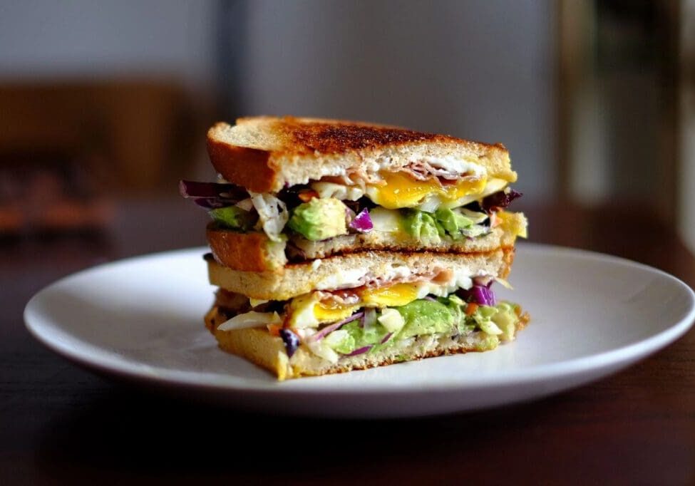 A sandwich cut in half on top of a plate.