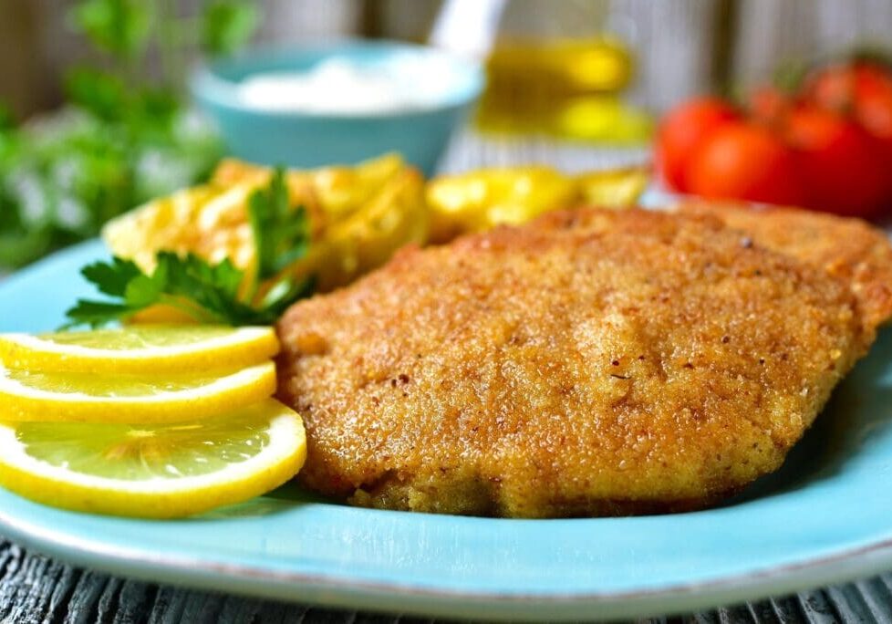 A plate of food with lemon and meat on it.