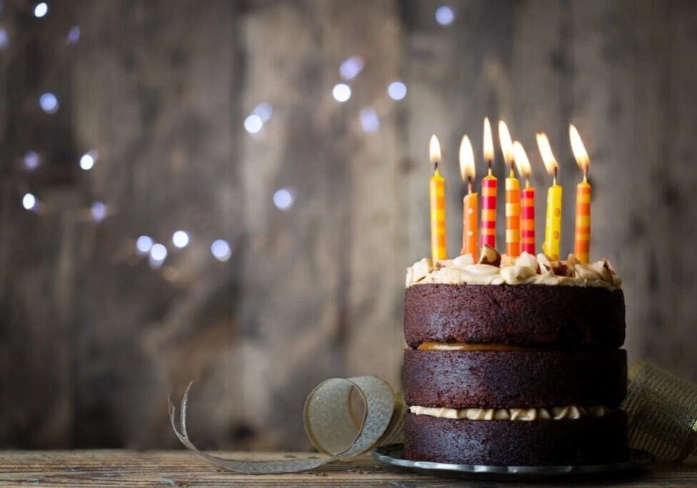 A cake with lit candles on top of it.