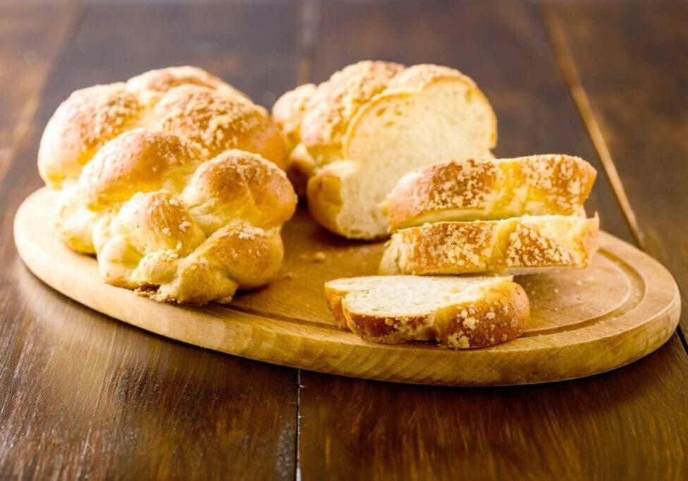 A wooden cutting board with some bread on it