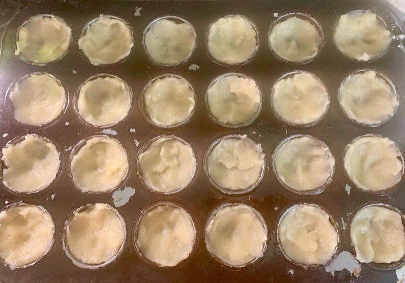 A tray of baked goods is shown in the process.