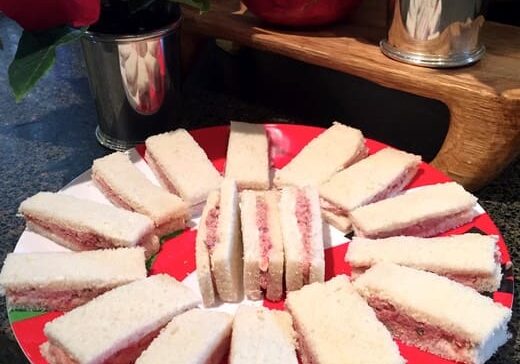 A red plate with sandwiches on it