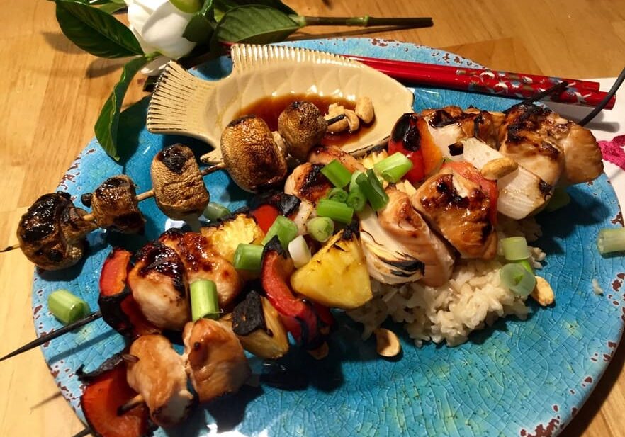 A plate of food on the table with flowers.