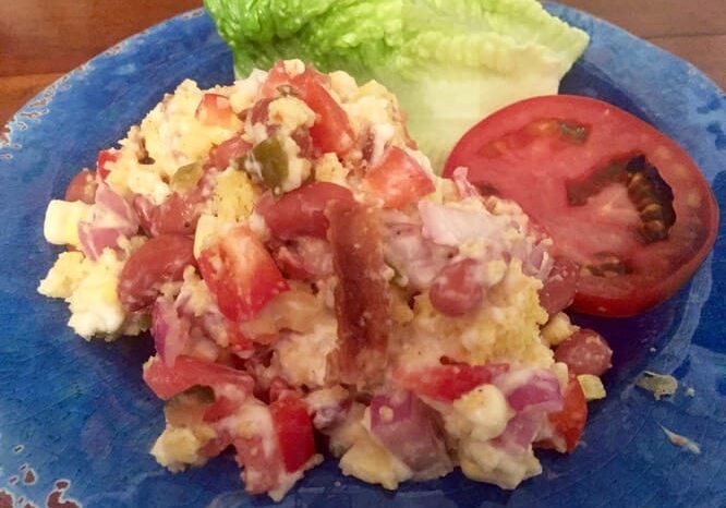 A blue plate with food on it and some lettuce