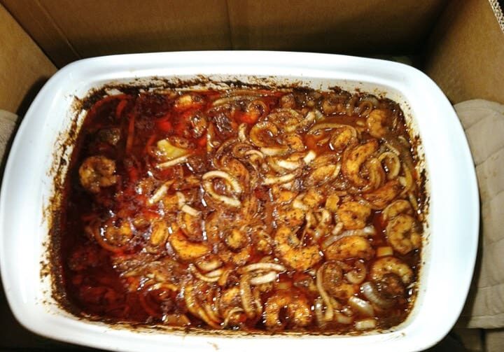 A casserole dish with meat and sauce in it.