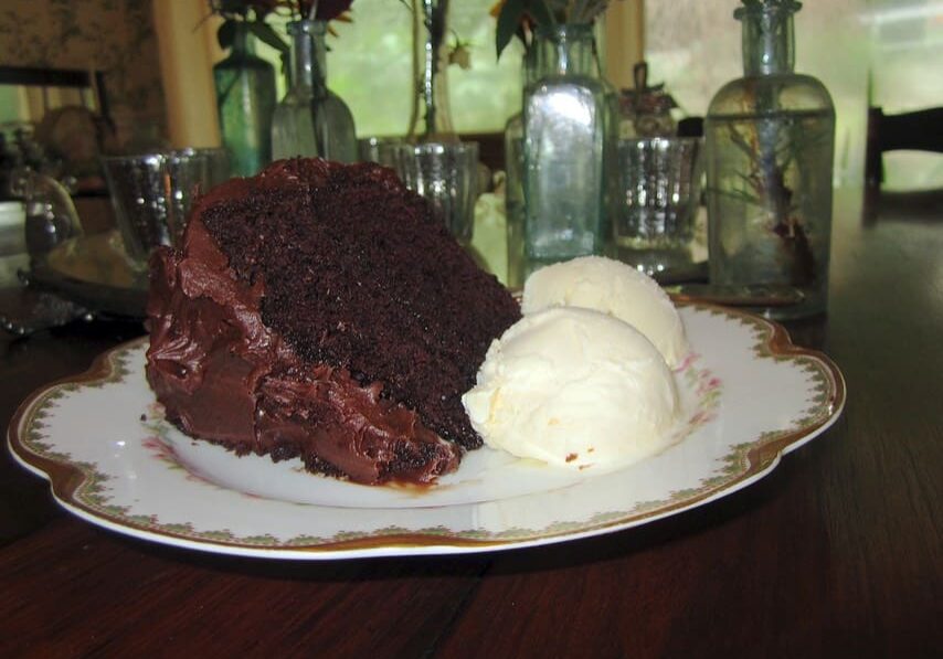 A plate of chocolate cake and ice cream on the table.