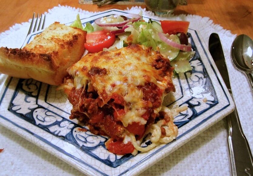 A plate of food with some type of meat and vegetables