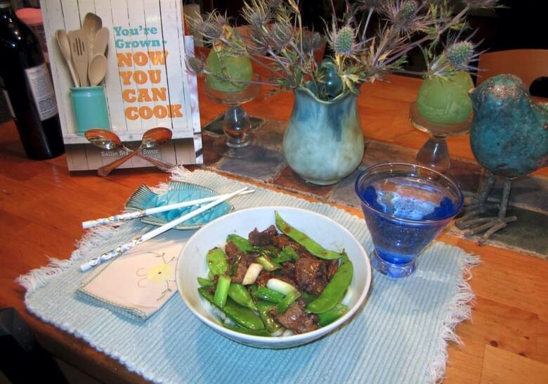 A bowl of food on the table with a book