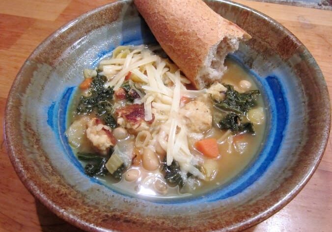 A bowl of soup with bread in it.