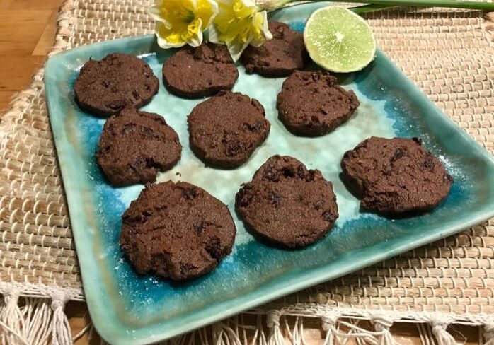 A plate of chocolate cookies on top of a table.