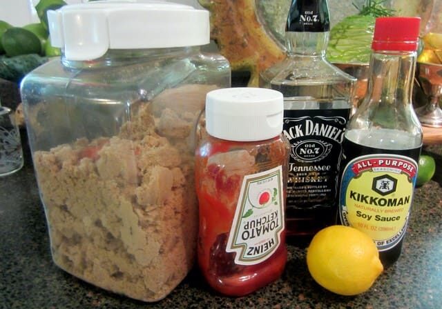 A jar of food and some drinks on the counter.