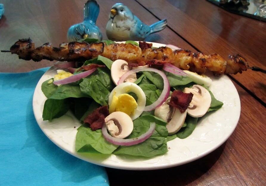 A plate of food with spinach and mushrooms on it.