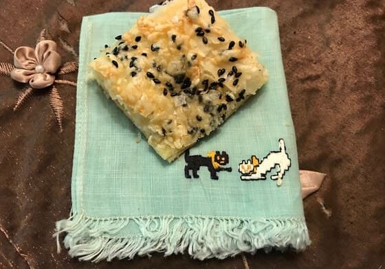 A piece of rice krispie treats on top of a blue towel.