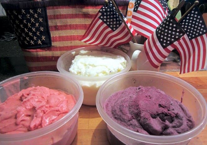 Three bowls of ice cream sitting on a table.