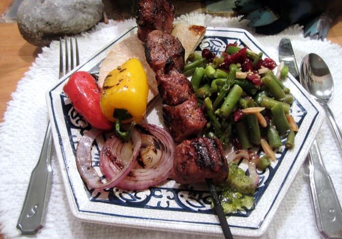 A plate of food with meat and vegetables on it.