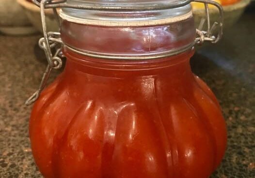 A jar of tomato sauce sitting on top of a table.