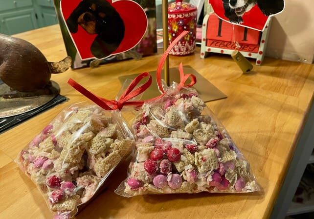 A table with two bags of candy and three other bags.