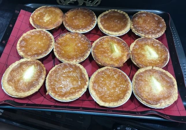 A tray of baked goods on top of the stove.