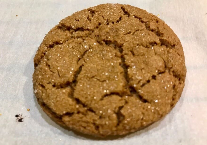 A cookie sitting on top of a white surface.