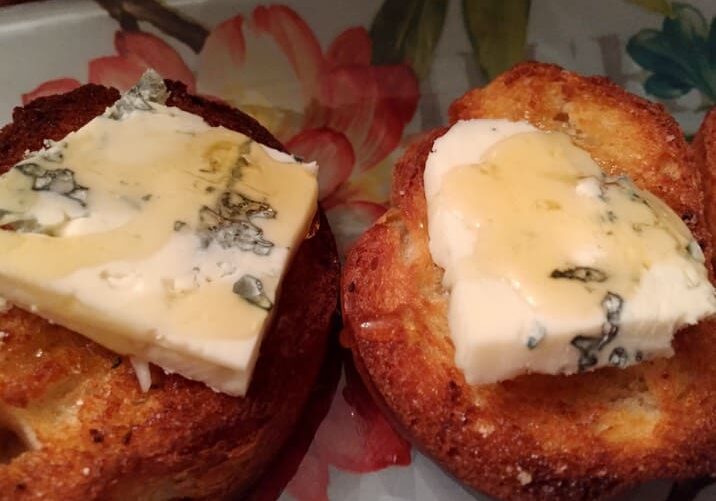 A close up of two pastries with butter on them