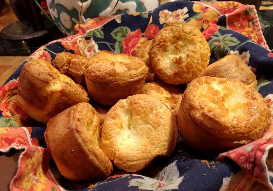 A bowl of muffins on top of a table.