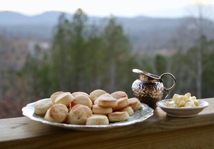 A plate of biscuits and butter on the table