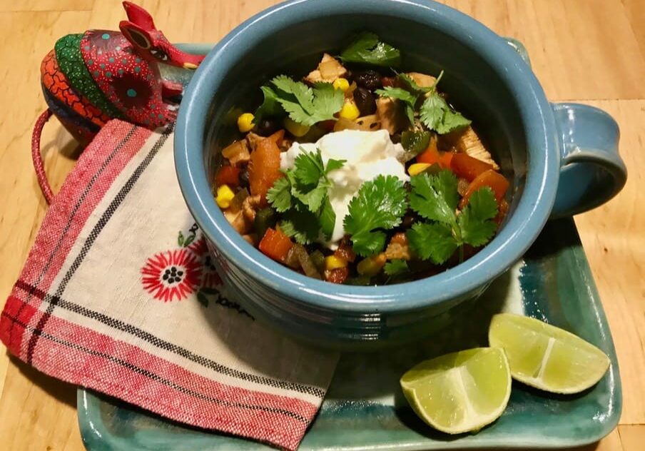 A bowl of food on top of a wooden table.