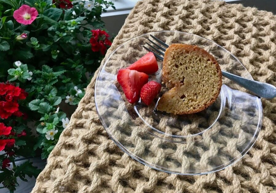 A plate with some strawberries and a piece of cake on it