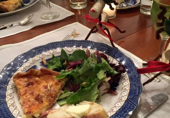 A plate of food on the table with wine glasses