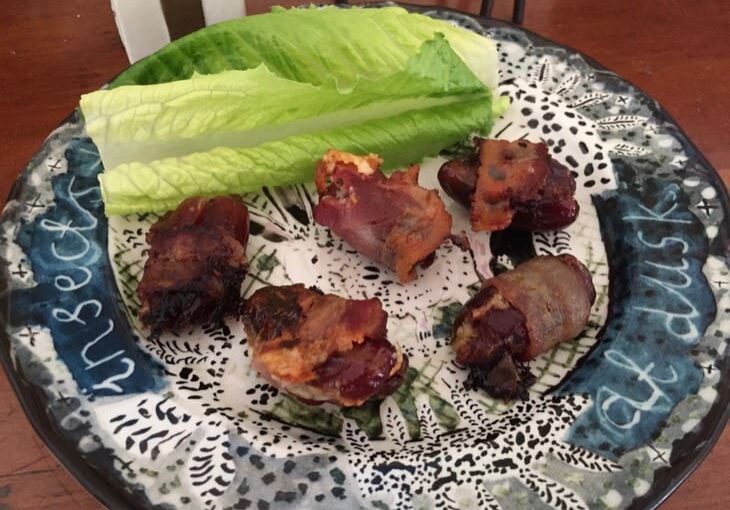 A plate with lettuce and meat on it.